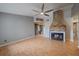 Open living room with a brick fireplace, neutral walls, and wood-look flooring at 5002 Bunyan St, Sarasota, FL 34232