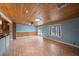 Bright living room with wood ceiling, tiled floors, and sliding door access to the outdoors at 5002 Bunyan St, Sarasota, FL 34232