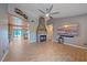 Spacious living room featuring a fireplace, a TV, and an open kitchen at 5002 Bunyan St, Sarasota, FL 34232