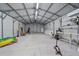 Interior of metal outbuilding with overhead lighting, concrete flooring and lots of space at 5002 Bunyan St, Sarasota, FL 34232