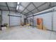 Large metal outbuilding interior with roll up doors and a concrete floor at 5002 Bunyan St, Sarasota, FL 34232