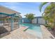 Beautiful backyard pool area with a blue storage unit and lush greenery, ideal for outdoor enjoyment at 5002 Bunyan St, Sarasota, FL 34232