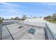 Wide shot of a rooftop patio with skylights and metal railings, overlooking the neighborhood at 5002 Bunyan St, Sarasota, FL 34232