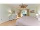 Bright bedroom with wood floors, ceiling fan, and balcony access for relaxing outdoors at 503 Spring Lakes Blvd # 503, Bradenton, FL 34210