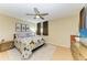 Bedroom with ceiling fan, wooden floor, and floral-themed bedding, offering a cozy retreat at 503 Spring Lakes Blvd # 503, Bradenton, FL 34210