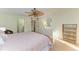 Bright bedroom with wood floors, ceiling fan, and balcony access for relaxing outdoors at 503 Spring Lakes Blvd # 503, Bradenton, FL 34210