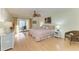 Bright bedroom with wood floors, ceiling fan, and balcony access for relaxing outdoors at 503 Spring Lakes Blvd # 503, Bradenton, FL 34210