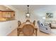 Dining area with wood table and chairs, and view to living room at 503 Spring Lakes Blvd # 503, Bradenton, FL 34210