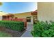 Inviting condo entrance with well-maintained landscaping, red latticework, and a welcoming 'HOME' sign at 503 Spring Lakes Blvd # 503, Bradenton, FL 34210