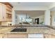 Kitchen sink featuring granite countertops and mosaic tile backsplash open to living area at 503 Spring Lakes Blvd # 503, Bradenton, FL 34210
