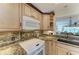 Kitchen featuring modern appliances, granite counters, and a great pass through to the main living area at 503 Spring Lakes Blvd # 503, Bradenton, FL 34210