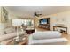 Bright living room with sliding glass doors and a ceiling fan for optimal lighting and comfort at 503 Spring Lakes Blvd # 503, Bradenton, FL 34210