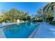 Community pool with lounge chairs and lush landscaping, perfect for relaxing and enjoying the sunshine at 503 Spring Lakes Blvd # 503, Bradenton, FL 34210
