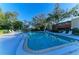 Community pool with lounge chairs and lush landscaping creating a serene and inviting atmosphere at 503 Spring Lakes Blvd # 503, Bradenton, FL 34210