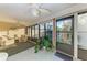Inviting sunroom featuring ceiling fan, large windows overlooking the property, indoor plants and comfortable seating at 503 Spring Lakes Blvd # 503, Bradenton, FL 34210