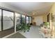 Bright sunroom featuring tile flooring, ceiling fan, lots of plants and a door to the interior of the home at 503 Spring Lakes Blvd # 503, Bradenton, FL 34210