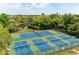 Community tennis courts surrounded by mature trees and a pond at 503 Spring Lakes Blvd # 503, Bradenton, FL 34210