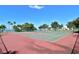 Outdoor tennis courts surrounded by trees and lush landscaping with a view of the bay at 537 Bahia Beach Boulevard, Ruskin, FL 33570