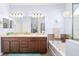 Bathroom with double vanity, soaking tub and tiled accents at 5814 117Th E Ter, Parrish, FL 34219