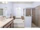 Bright bathroom with walk-in shower and large soaking tub at 5814 117Th E Ter, Parrish, FL 34219