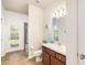 Cozy bathroom featuring a single vanity, mirror, tiled floors, and an adjacent shower area at 5814 117Th E Ter, Parrish, FL 34219