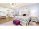 Bright main bedroom with sitting area, plush purple accents and ensuite bathroom access at 5814 117Th E Ter, Parrish, FL 34219