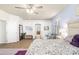 Well-lit bedroom features a plush bed, stylish furniture, and seamless access to ensuite bathroom at 5814 117Th E Ter, Parrish, FL 34219