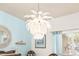 Palm-shaped chandelier in the dining area with light blue walls and coastal decor at 5814 117Th E Ter, Parrish, FL 34219