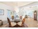 Bright dining room featuring an elegant chandelier, round table and a large window at 5814 117Th E Ter, Parrish, FL 34219