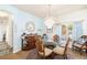 Dining room featuring a round table, elegant chandelier, and light blue walls at 5814 117Th E Ter, Parrish, FL 34219