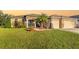 Beautiful single-story home with a lush green lawn, stone accents, and a two-car garage at 5814 117Th E Ter, Parrish, FL 34219