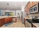 Well-equipped kitchen boasts stainless steel appliances, granite countertops, and views of the living spaces at 5814 117Th E Ter, Parrish, FL 34219