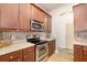 Well-appointed kitchen with stainless steel appliances, wood cabinetry, and easy access to other rooms at 5814 117Th E Ter, Parrish, FL 34219
