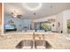 Modern kitchen features granite countertops, stainless steel sink and view into the living room at 5814 117Th E Ter, Parrish, FL 34219