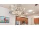 Stylish light fixtures illuminate the modern kitchen with stainless steel appliances and cabinets at 5814 117Th E Ter, Parrish, FL 34219