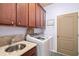 Laundry room includes front loading washer and dryer with a sink with stone countertops and plenty of cabinet storage at 5814 117Th E Ter, Parrish, FL 34219