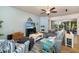 Bright living room offering comfortable seating, a large TV, and seamless access to the outdoor area at 5814 117Th E Ter, Parrish, FL 34219