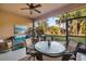 Screened patio with comfortable seating, a round table, and views of the tropical backyard at 5814 117Th E Ter, Parrish, FL 34219