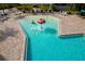 Aerial view of a community pool featuring a shallow play area with a mushroom-shaped water fountain and lounge chairs at 5814 117Th E Ter, Parrish, FL 34219
