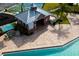 Aerial view of a community pool house with seating areas, a lifeguard station, and well-maintained landscaping at 5814 117Th E Ter, Parrish, FL 34219
