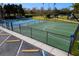 Community sport court featuring basketball and pickleball courts, surrounded by lush landscaping and a parking area at 5814 117Th E Ter, Parrish, FL 34219
