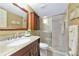 Bathroom featuring a granite countertop, a single sink vanity, and a shower with glass doors at 617 Estuary Dr # 617, Bradenton, FL 34209