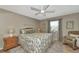 Comfortable bedroom with floral bedding, neutral decor, and a window providing natural light at 617 Estuary Dr # 617, Bradenton, FL 34209