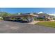 Wide shot of building carport with assigned parking and mature landscaping around the building at 617 Estuary Dr # 617, Bradenton, FL 34209