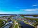 Picturesque aerial view of the waterfront community with pristine landscaping, pools, tennis courts, and stunning water views at 617 Estuary Dr # 617, Bradenton, FL 34209