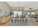 Bright dining room with hardwood flooring, modern chandelier, and sliding door to screened lanai at 617 Estuary Dr # 617, Bradenton, FL 34209