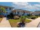 Condo exterior shows meticulous landscaping around building with neutral color scheme and white trim at 617 Estuary Dr # 617, Bradenton, FL 34209