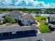 Charming view of the property featuring well-maintained landscaping and convenient carport parking at 617 Estuary Dr # 617, Bradenton, FL 34209