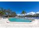 Enjoy the refreshing community pool with a lake view, lounge chairs, and lush landscaping at 617 Estuary Dr # 617, Bradenton, FL 34209