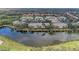 Aerial view of community with water views, lush trees, and well maintained landscaping at 6326 Grand Oak Cir # 203, Bradenton, FL 34203